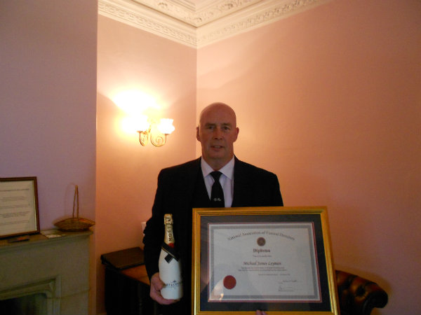 Michael Leyman with certificate and bottle of champagne